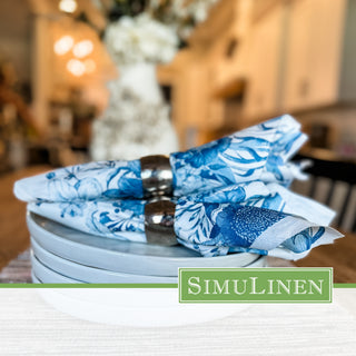 SimuLinen Blue Garden luxury paper dinner napkins in a silver-colored napkin ring.