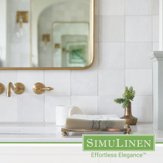 Image of silver magnolia guest towels on a bathroom sink.