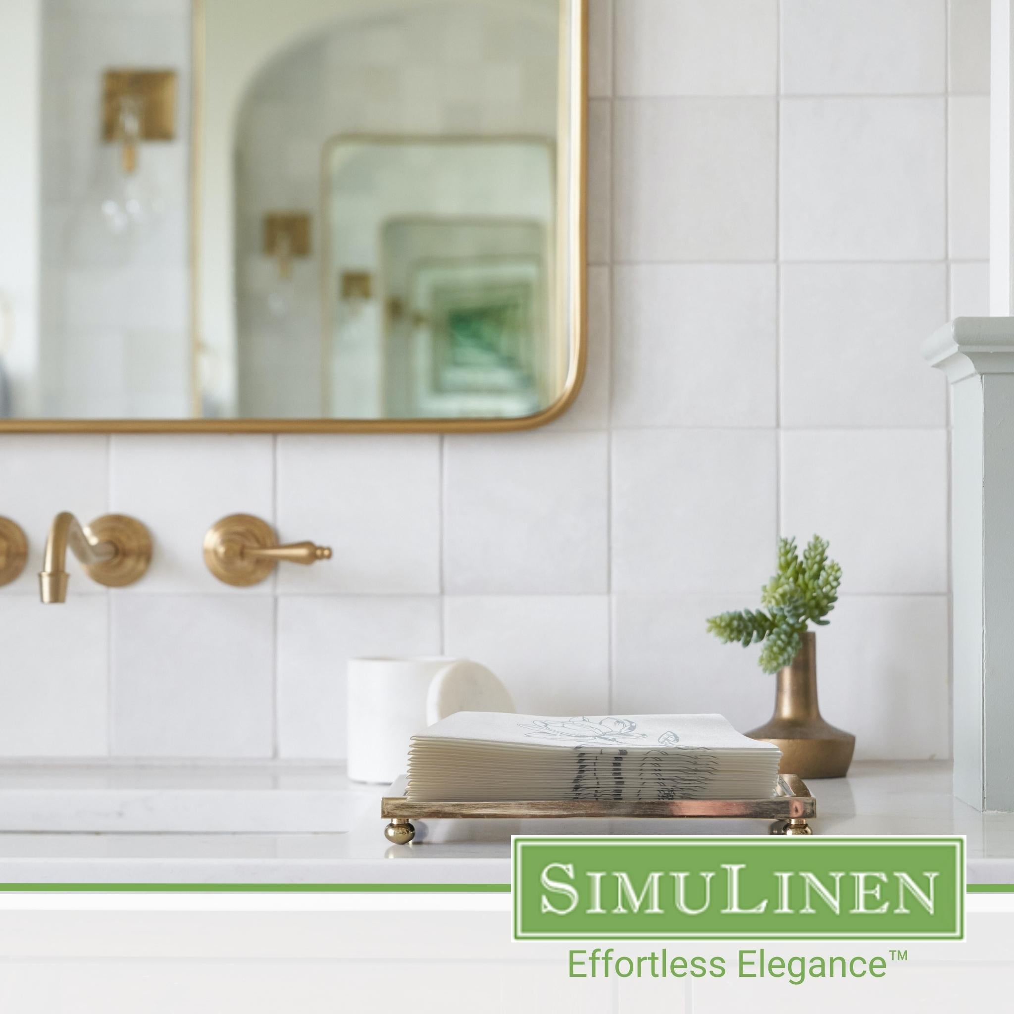 Image of silver magnolia guest towels on a bathroom sink.