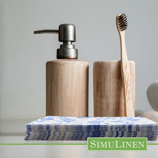Image of blue nautical guest towels in a bathroom with a soap dispenser and a toothbrush behind them.