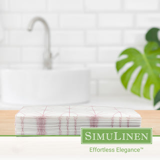 Image of rose gold geometric design guest towels on a wooden board with a bathroom sink in the background.