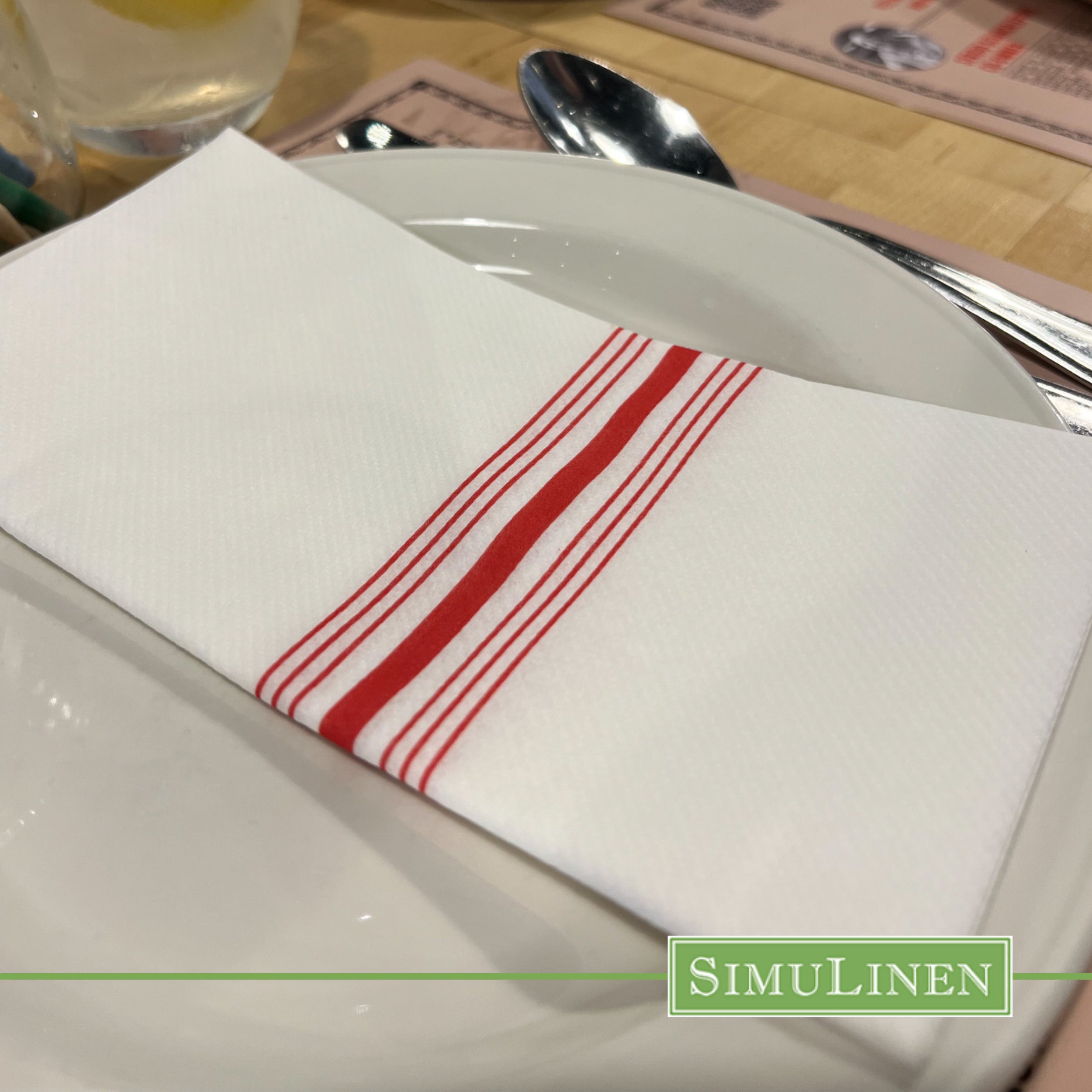 Red bistro stripe SimuLinen select dinner napkin close up on white plate