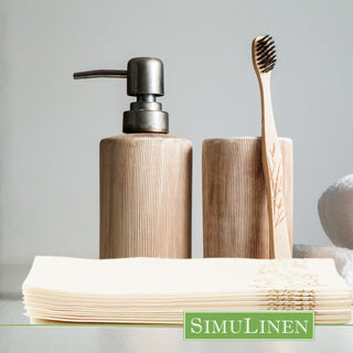 Image of Gold Floral guest towels with a soap dispenser and a toothbrush in the background.