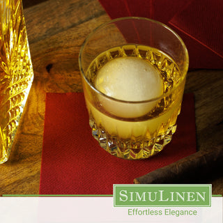 SimuLinen burgundy cocktail napkins with a glass of whiskey.