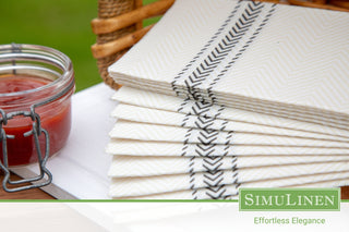 A close-up of SimuLinen black bistro ClassicPoint napkins in a picnic setting.