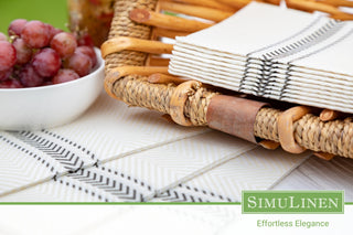 A picture of a picnic setting with ClassicPoint black bistro napkins and a bowl of red grapes.