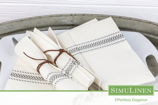 An image of silverware elegantly wrapped in SimuLinen Black Bistro ClassicPoint napkins.
