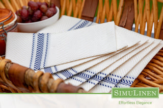 SimuLinen ClassicPoint blue bistro napkins in a picnic basket.