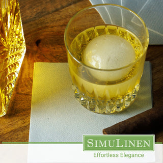 SimuLinen rich grey cocktail napkins with a glass of whiskey.