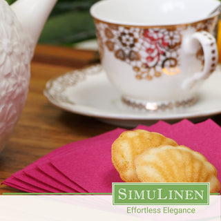 Magenta disposable luxury paper napkins with a fancy tea cup in the background.