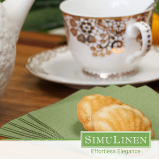 Olive green beverage napkins with a fancy tea cup in the background.