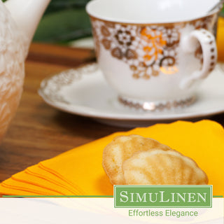 SimuLinen orange beverage napkins with a fancy teacup in the background.