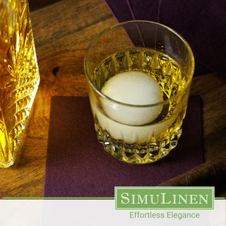 SimuLinen Plum beverage napkins with a glass of whiskey on top.