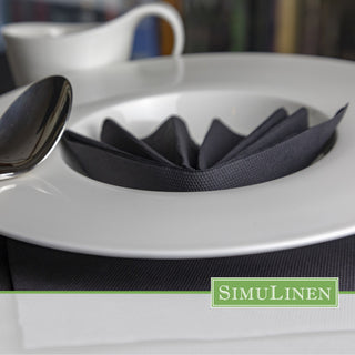 SimuLinen Solid Black ClassicPoint napkin folded into a fan shape.