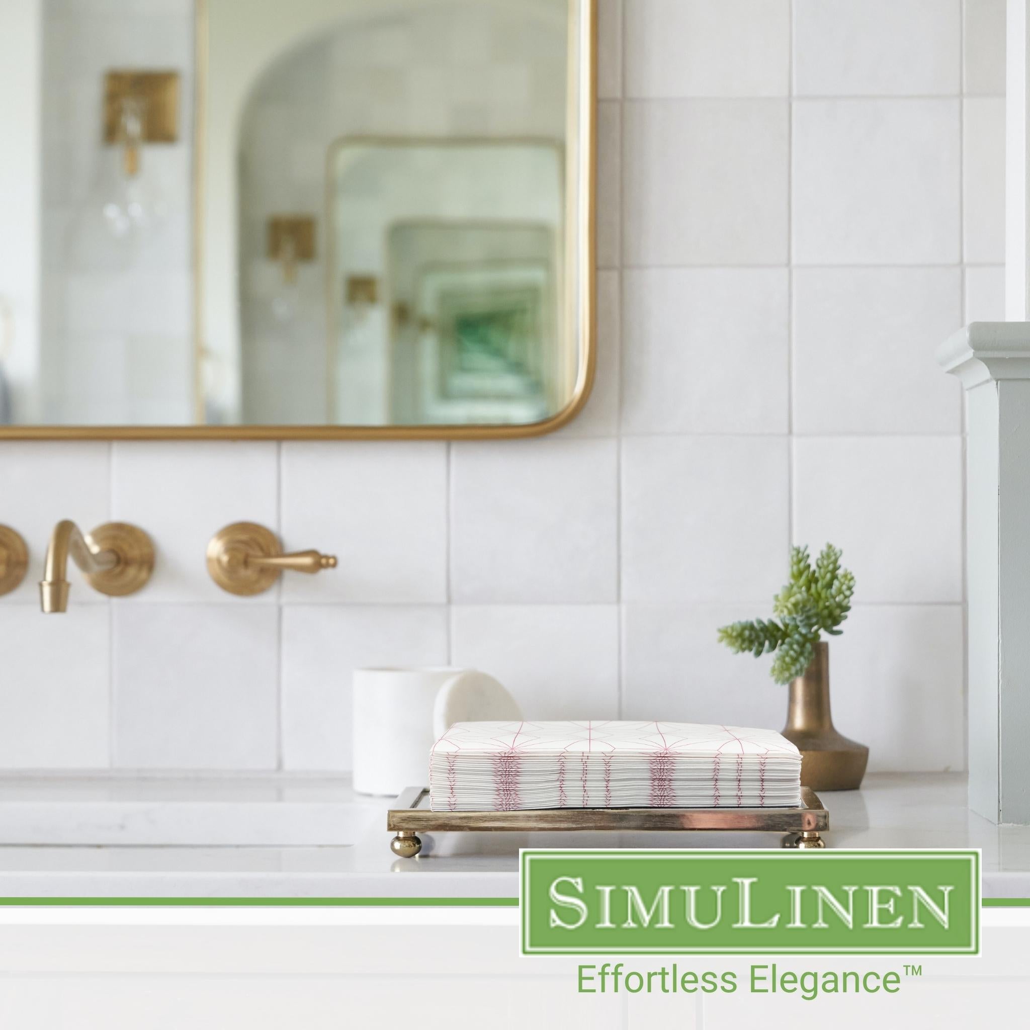 Image of rose gold geometric design guest towels with a bathroom sink in the background.