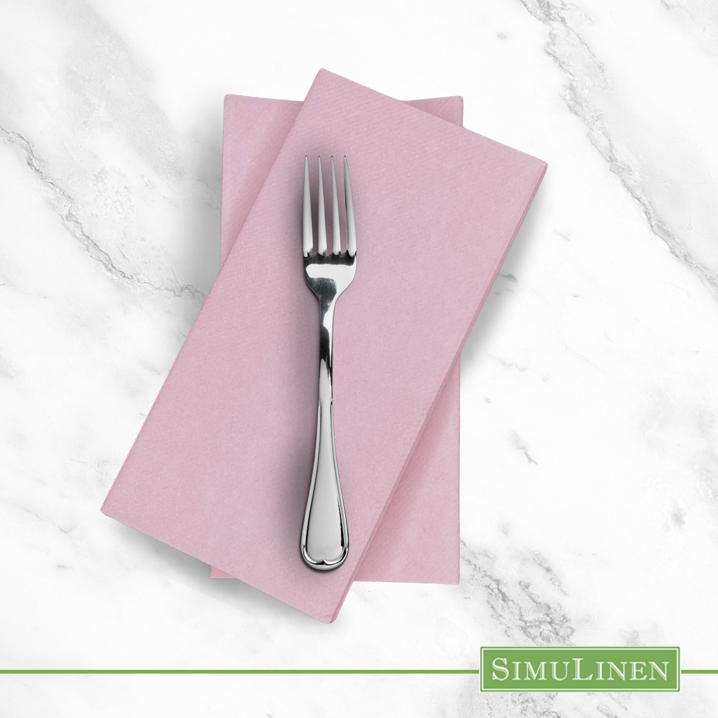 Dusty rose pink SimuLinen dinner napkin on marble counter with fork