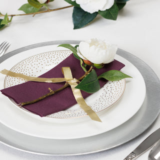 Plum dinner napkin on formal setting with flower