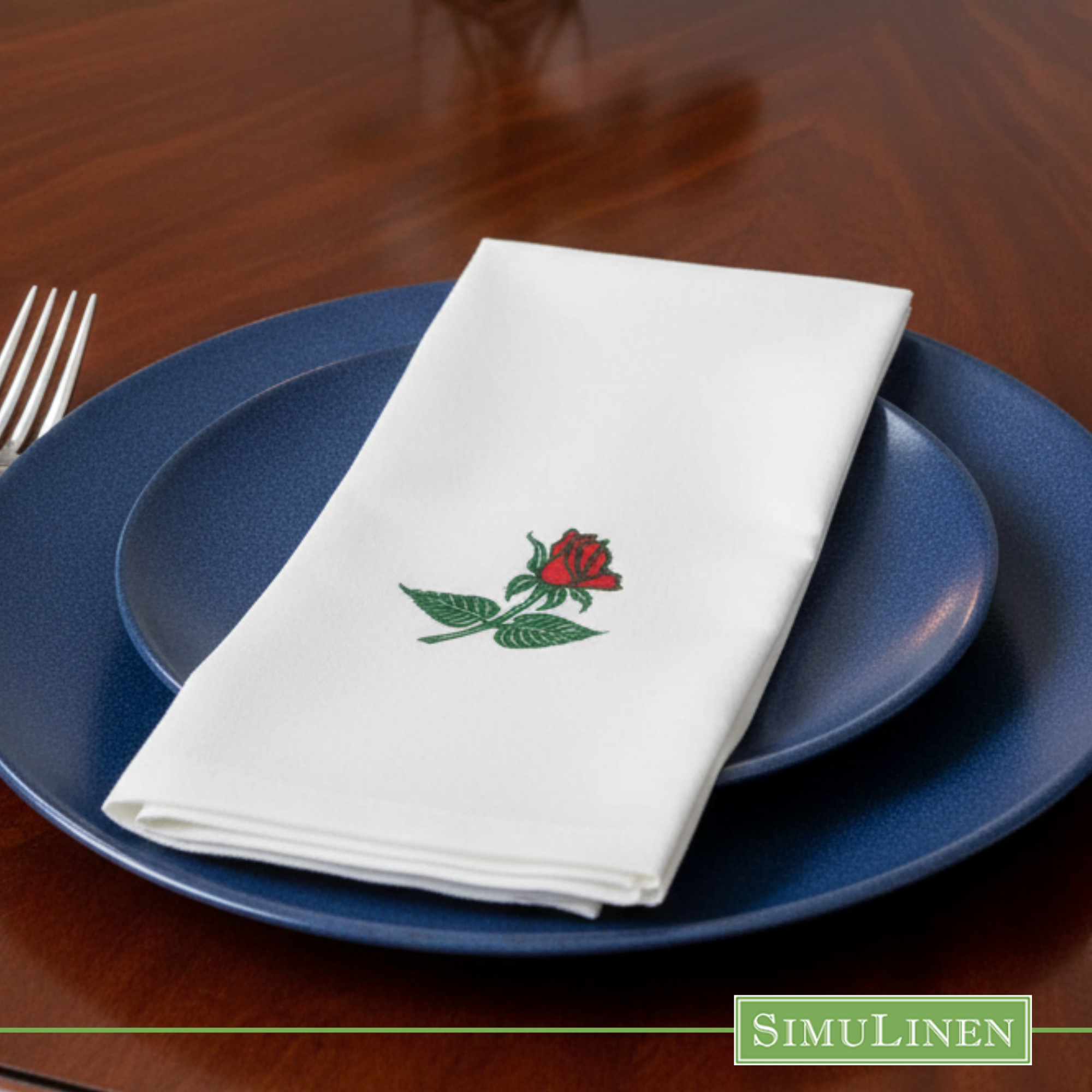 Rose SimuLinen dinner napkin on blue plate