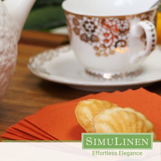 SimuLinen terracotta beverage napkins with a fancy tea cup in the background.