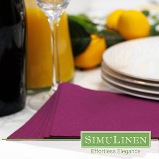 Image of aubergine beverage napkins in a dinner setting.