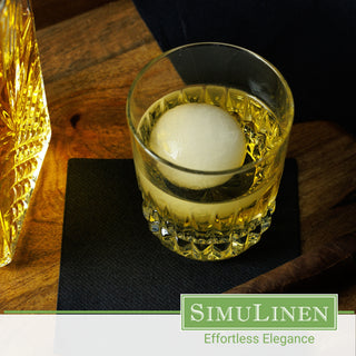 SimuLinen black beverage napkins underneath a whiskey glass.