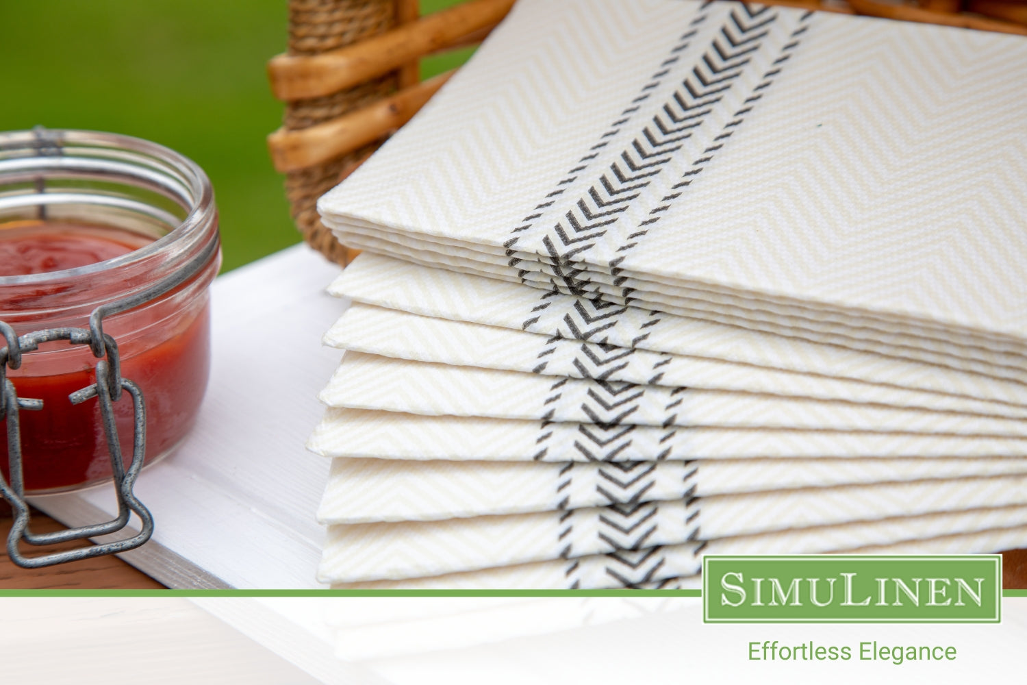 A close-up of SimuLinen black bistro ClassicPoint napkins in a picnic setting.
