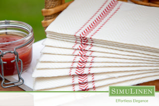A stack or SimuLinen Red Bistro ClassicPoint napkins in a picnic setting.