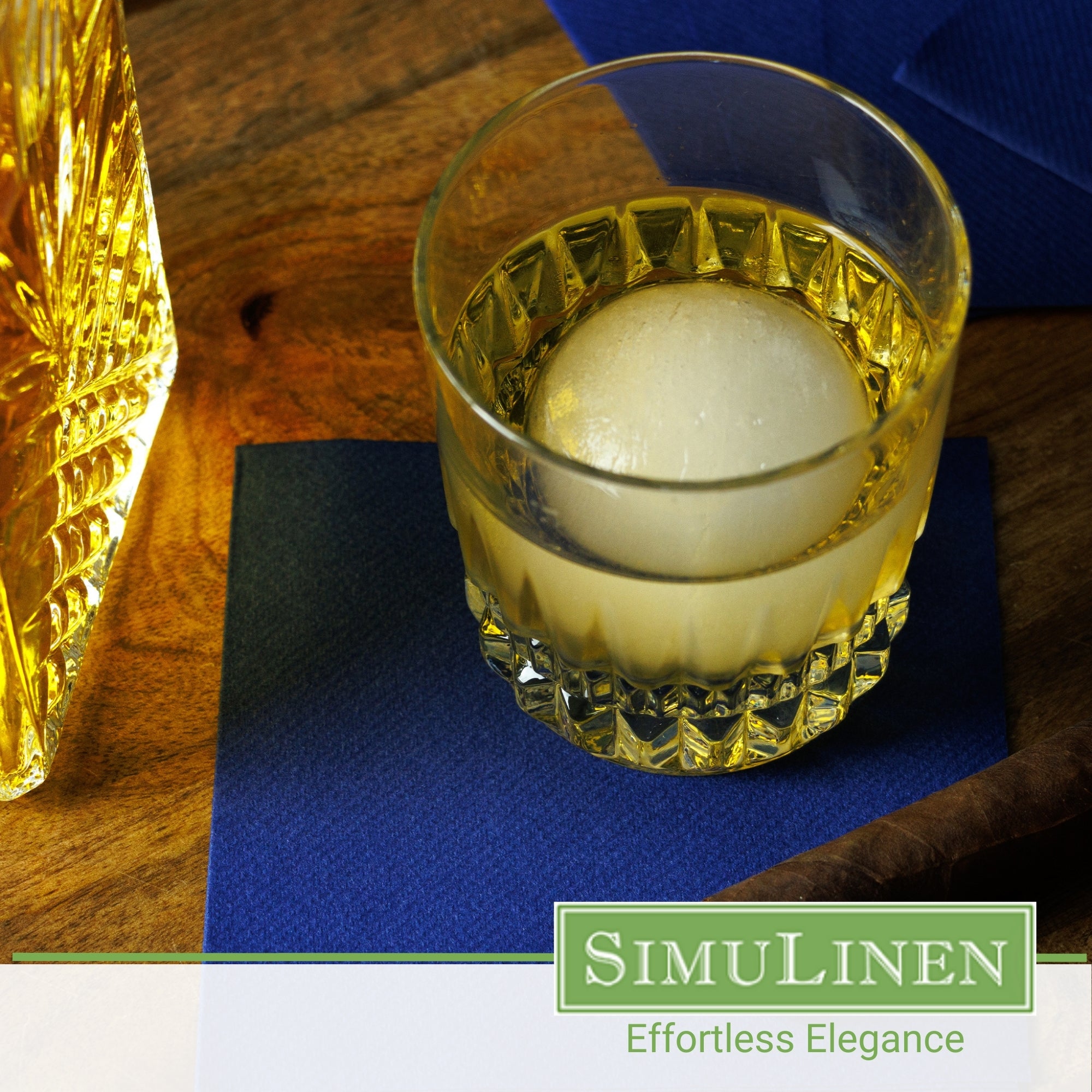 SimuLinen dark blue beverage napkins underneath a whiskey glass.