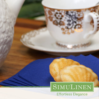 SimuLinen dark blue beverage napkins with a fancy tea cup in the background.