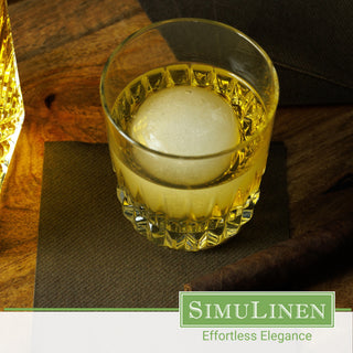 SimuLinen dark brown beverage napkins underneath a whiskey glass.