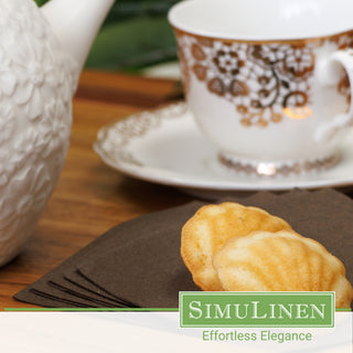 SimuLinen chocolate brown disposable cocktail napkins with a fancy tea cup in the background.