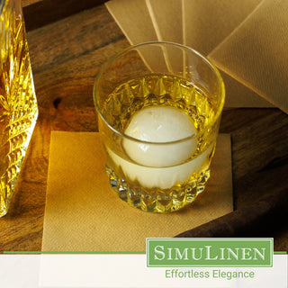 SimuLinen natural brown beverage napkins with a glass of whiskey on top.