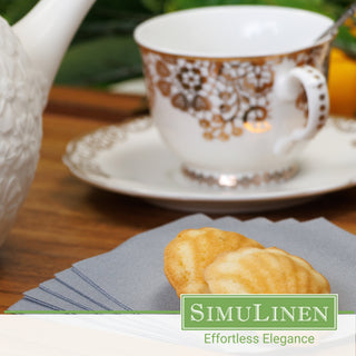 SimuLinen Silver beverage napkins with a fancy tea cup in the background.